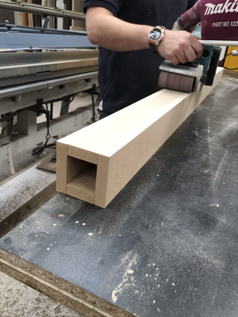 Image of the bespoke wall divider being sanded